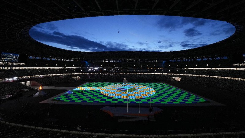 Flags are carried in during the closing ceremony in the Olympic Stadium at the 2020 Summer Olympics, Sunday, Aug. 8, 2021, in Tokyo, Japan. (AP Photo/Charlie Riedel)