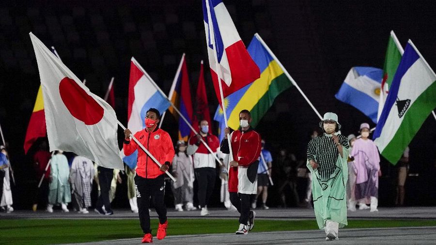 Flags are carried in during the closing ceremony in the Olympic Stadium at the 2020 Summer Olympics, Sunday, Aug. 8, 2021, in Tokyo, Japan. (AP Photo/Charlie Riedel)