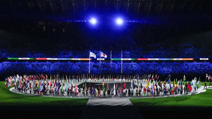 Flags are carried in during the closing ceremony in the Olympic Stadium at the 2020 Summer Olympics, Sunday, Aug. 8, 2021, in Tokyo, Japan. (AP Photo/Charlie Riedel)