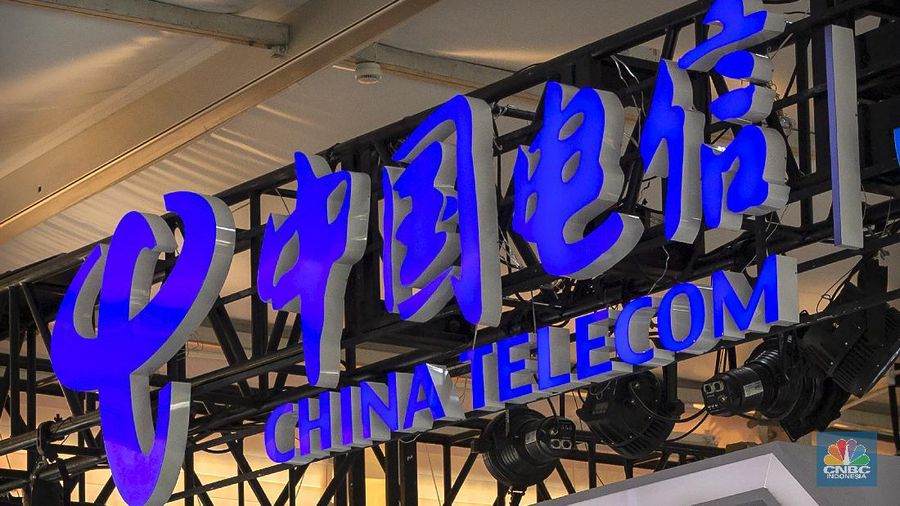 FILE - In this Sept. 5, 2020, file photo, the logo for Chinese telecommunications firm China Telecom is seen on a booth at the China International Fair for Trade in Services (CIFTIS) in Beijing. The New York Stock Exchange says it no longer plans to remove shares of three Chinese state-owned phone carriers under an order by President Donald Trump. (AP Photo/Mark Schiefelbein, File)