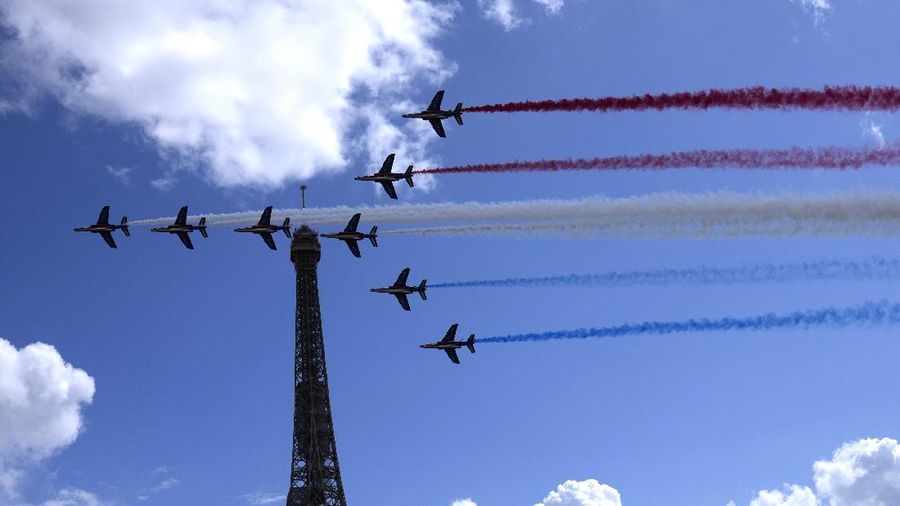 The French Aerial Patrol fly by the Eiffel Tower and over the Olympics fan zone in Paris, Sunday, Aug. 8, 2021. Celebrations were held in Paris Sunday as part of the handover ceremony of Tokyo 2020 to Paris 2024, as Paris will be the next Summer Games host in 2024. The passing of the hosting baton will be split between the Olympic Stadium in Tokyo and a public party and concert in Paris. (AP Photo/Francois Mori)