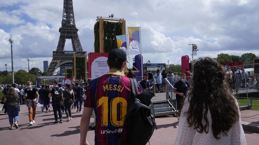 Spectators gather at the Olympics fan zone in the Trocadero Gardens in front of the Eiffel Tower in Paris, Sunday, Aug. 8, 2021. Celebrations were held in Paris Sunday as part of the handover ceremony of Tokyo 2020 to Paris 2024, as Paris will be the next Summer Games host in 2024. The passing of the hosting baton will be split between the Olympic Stadium in Tokyo and a public party and concert in Paris. (AP Photo/Francois Mori)