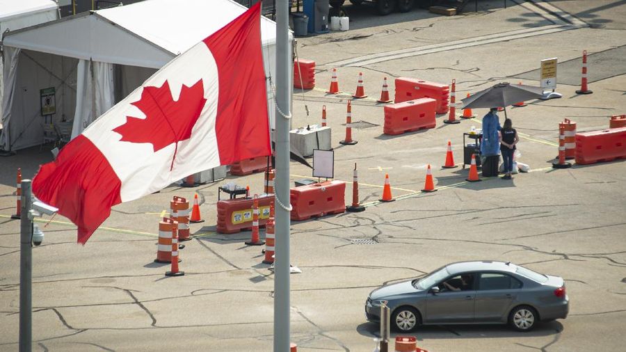 Car cross the border into Canada, in Niagara Falls, Ontario, on Monday, Aug. 9, 2021. American citizens and permanent residents are now allowed to enter Canada for non-essential purposes if they can provide proof that they've been fully vaccinated for at least 14 days. (Eduardo Lima/The Canadian Press via AP)