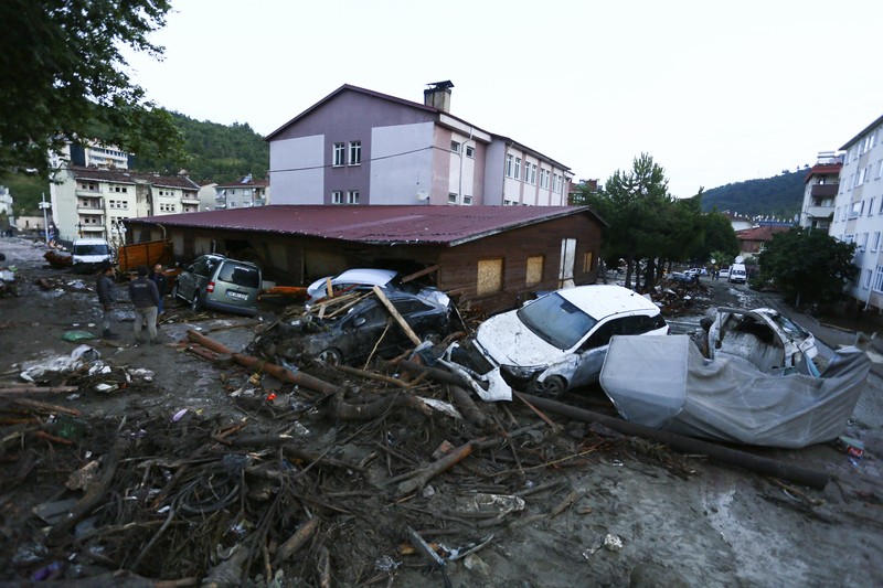 Turkey Floods Destroyed cars in a street after floods and mudslides in Bozkurt town of Kastamonu province, Thursday, Aug. 12, 2021. The floods triggered by torrential rains battered the Black Sea coastal provinces of Bartin, Kastamonu, Sinop and Samsun on Wednesday, demolishing homes and bridges and sweeping cars away by torrents. Helicopters scrambled to rescue people stranded on rooftops.(IHA via AP)