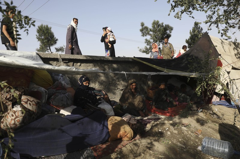 Afghanistan Internally displaced Afghans from northern provinces, who fled their home due to fighting between the Taliban and Afghan security personnel, take refuge in a public park Kabul, Afghanistan, Friday, Aug. 13, 2021. The Taliban have completed their sweep of the country's south on Friday, as they took four more provincial capitals in a lightning offensive that is gradually encircling Kabul, just weeks before the U.S. is set to officially end its two-decade war. (AP Photo/Rahmat Gul)