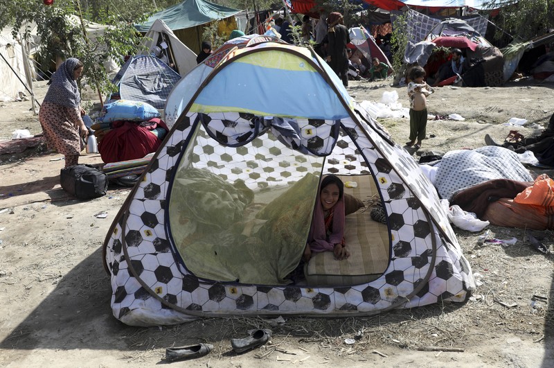 Afghanistan Internally displaced Afghans from northern provinces, who fled their home due to fighting between the Taliban and Afghan security personnel, take refuge in a public park Kabul, Afghanistan, Friday, Aug. 13, 2021. The Taliban have completed their sweep of the country's south on Friday, as they took four more provincial capitals in a lightning offensive that is gradually encircling Kabul, just weeks before the U.S. is set to officially end its two-decade war. (AP Photo/Rahmat Gul)