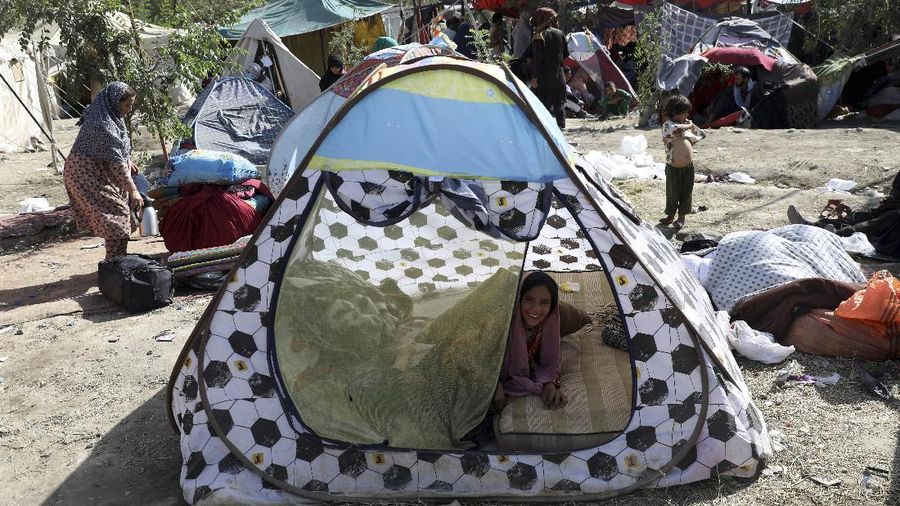 Internally displaced Afghans from northern provinces, who fled their home due to fighting between the Taliban and Afghan security personnel, take refuge in a public park Kabul, Afghanistan, Friday, Aug. 13, 2021. The Taliban have completed their sweep of the country's south on Friday, as they took four more provincial capitals in a lightning offensive that is gradually encircling Kabul, just weeks before the U.S. is set to officially end its two-decade war. (AP Photo/Rahmat Gul)