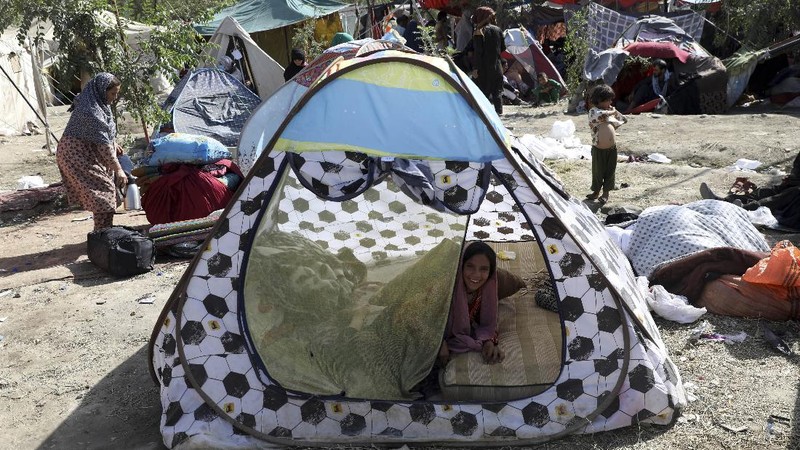 Internally displaced Afghans from northern provinces, who fled their home due to fighting between the Taliban and Afghan security personnel, take refuge in a public park Kabul, Afghanistan, Friday, Aug. 13, 2021. The Taliban have completed their sweep of the country's south on Friday, as they took four more provincial capitals in a lightning offensive that is gradually encircling Kabul, just weeks before the U.S. is set to officially end its two-decade war. (AP Photo/Rahmat Gul)