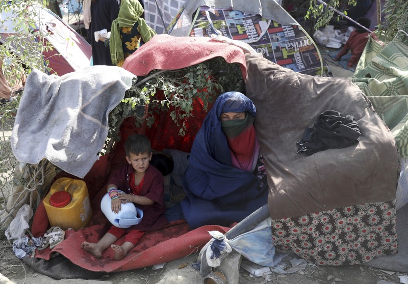 Afghanistan Internally displaced Afghans from northern provinces, who fled their home due to fighting between the Taliban and Afghan security personnel, take refuge in a public park Kabul, Afghanistan, Friday, Aug. 13, 2021. The Taliban have completed their sweep of the country's south on Friday, as they took four more provincial capitals in a lightning offensive that is gradually encircling Kabul, just weeks before the U.S. is set to officially end its two-decade war. (AP Photo/Rahmat Gul)