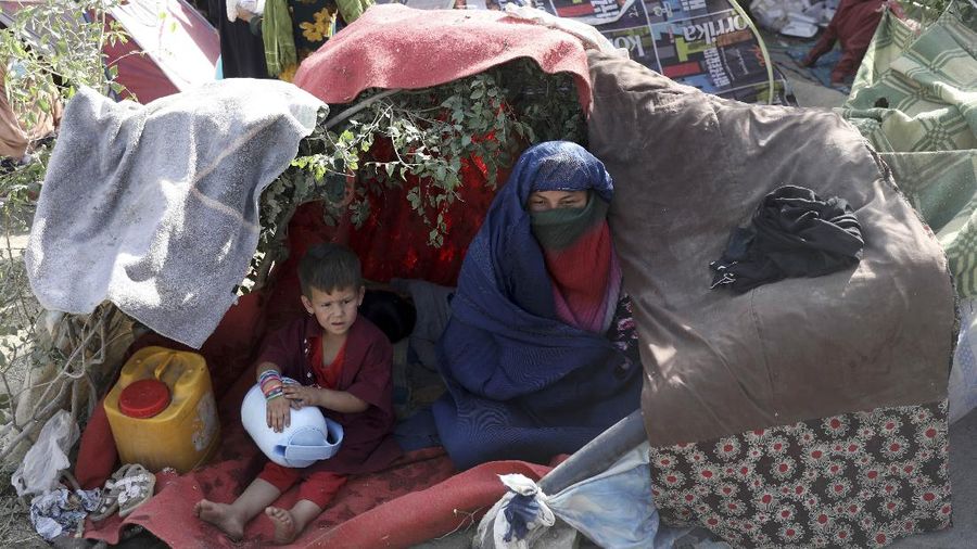 Internally displaced Afghans from northern provinces, who fled their home due to fighting between the Taliban and Afghan security personnel, take refuge in a public park Kabul, Afghanistan, Friday, Aug. 13, 2021. The Taliban have completed their sweep of the country's south on Friday, as they took four more provincial capitals in a lightning offensive that is gradually encircling Kabul, just weeks before the U.S. is set to officially end its two-decade war. (AP Photo/Rahmat Gul)