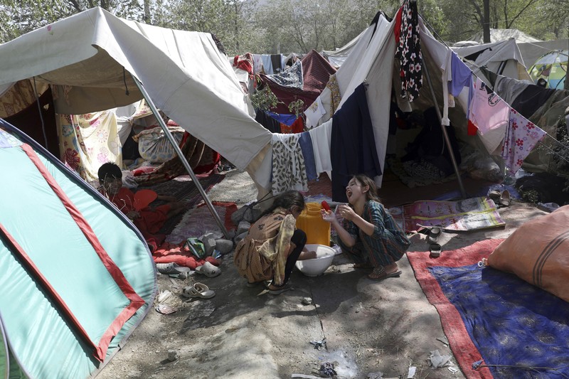 Afghanistan Internally displaced Afghans from northern provinces, who fled their home due to fighting between the Taliban and Afghan security personnel, take refuge in a public park Kabul, Afghanistan, Friday, Aug. 13, 2021. The Taliban have completed their sweep of the country's south on Friday, as they took four more provincial capitals in a lightning offensive that is gradually encircling Kabul, just weeks before the U.S. is set to officially end its two-decade war. (AP Photo/Rahmat Gul)