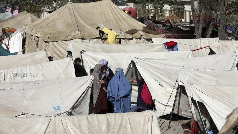 Internally displaced Afghans from northern provinces, who fled their home due to fighting between the Taliban and Afghan security personnel, take refuge in a public park Kabul, Afghanistan, Friday, Aug. 13, 2021. The Taliban have completed their sweep of the country's south on Friday, as they took four more provincial capitals in a lightning offensive that is gradually encircling Kabul, just weeks before the U.S. is set to officially end its two-decade war. (AP Photo/Rahmat Gul)