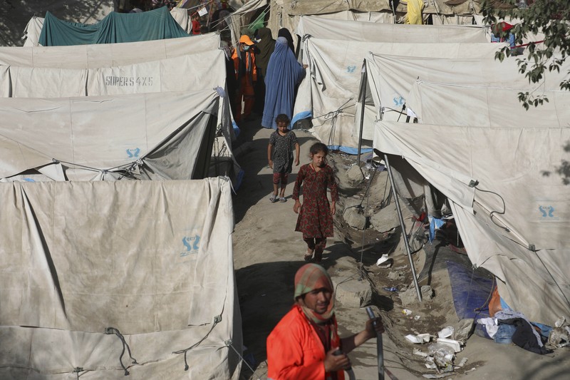 Afghanistan Internally displaced Afghans from northern provinces, who fled their home due to fighting between the Taliban and Afghan security personnel, take refuge in a public park Kabul, Afghanistan, Friday, Aug. 13, 2021. The Taliban have completed their sweep of the country's south on Friday, as they took four more provincial capitals in a lightning offensive that is gradually encircling Kabul, just weeks before the U.S. is set to officially end its two-decade war. (AP Photo/Rahmat Gul)