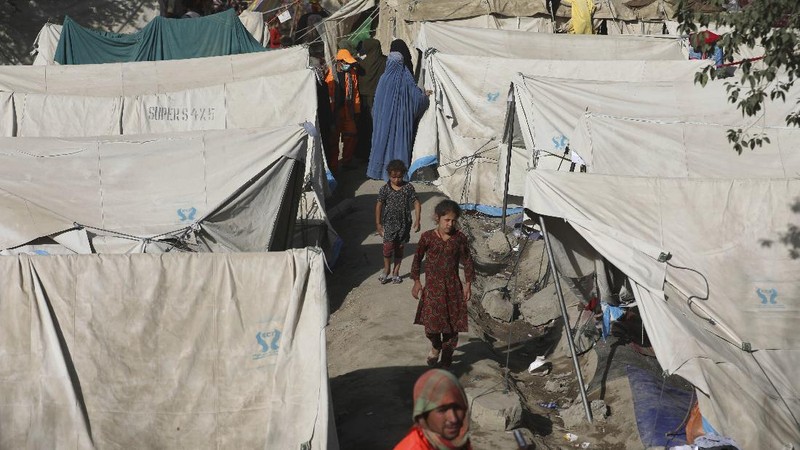 Internally displaced Afghans from northern provinces, who fled their home due to fighting between the Taliban and Afghan security personnel, take refuge in a public park Kabul, Afghanistan, Friday, Aug. 13, 2021. The Taliban have completed their sweep of the country's south on Friday, as they took four more provincial capitals in a lightning offensive that is gradually encircling Kabul, just weeks before the U.S. is set to officially end its two-decade war. (AP Photo/Rahmat Gul)