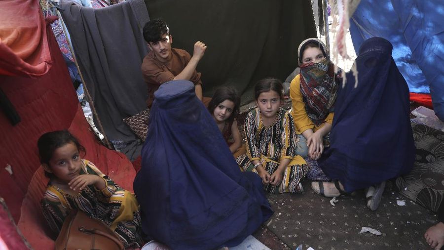Internally displaced Afghans from northern provinces, who fled their home due to fighting between the Taliban and Afghan security personnel, take refuge in a public park Kabul, Afghanistan, Friday, Aug. 13, 2021. The Taliban have completed their sweep of the country's south on Friday, as they took four more provincial capitals in a lightning offensive that is gradually encircling Kabul, just weeks before the U.S. is set to officially end its two-decade war. (AP Photo/Rahmat Gul)