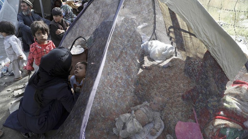 Internally displaced Afghans from northern provinces, who fled their home due to fighting between the Taliban and Afghan security personnel, take refuge in a public park Kabul, Afghanistan, Friday, Aug. 13, 2021. The Taliban have completed their sweep of the country's south on Friday, as they took four more provincial capitals in a lightning offensive that is gradually encircling Kabul, just weeks before the U.S. is set to officially end its two-decade war. (AP Photo/Rahmat Gul)