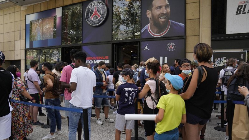 Jerseys bearing the name of Lionel Messi hang with some reading 