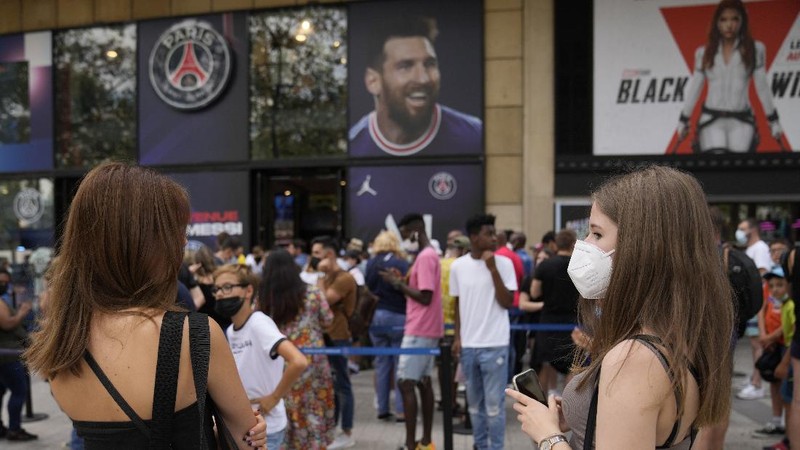 Jerseys bearing the name of Lionel Messi hang with some reading 