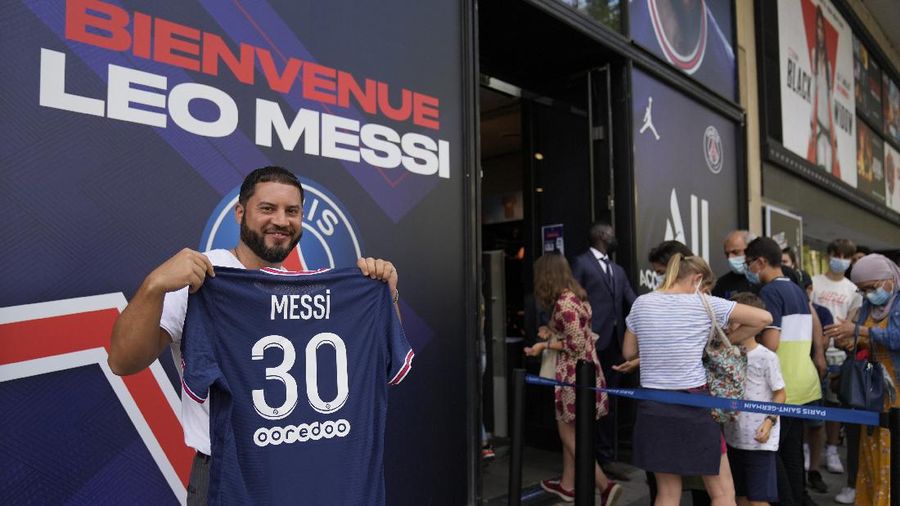 Jerseys bearing the name of Lionel Messi hang with some reading 