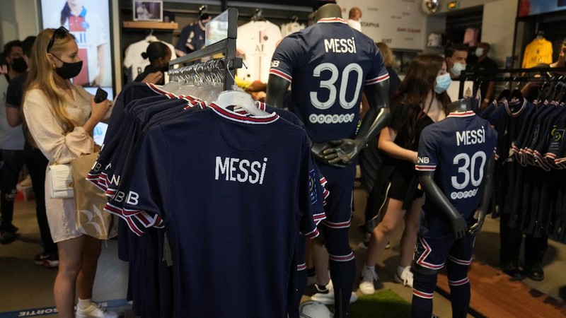 Jerseys bearing the name of Lionel Messi hang with some reading 