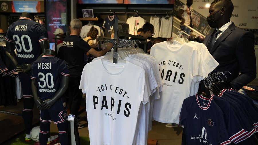 Jerseys bearing the name of Lionel Messi hang with some reading 