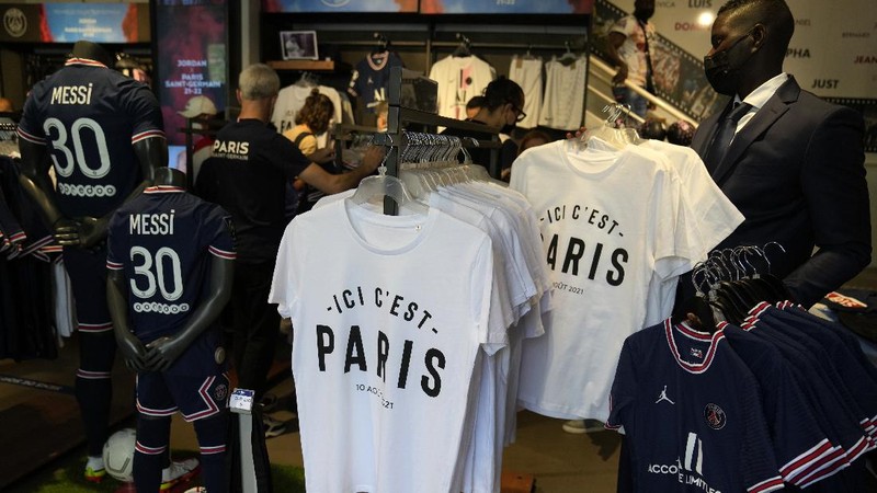 Jerseys bearing the name of Lionel Messi hang with some reading 