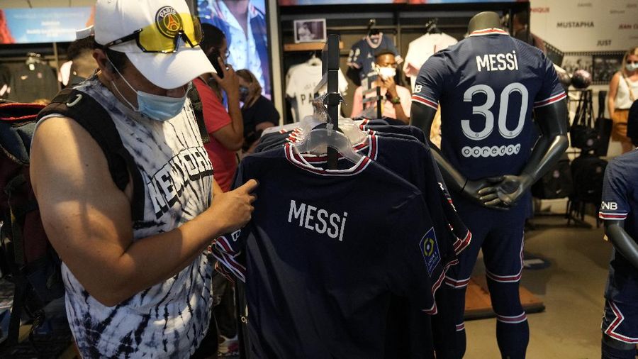 Jerseys bearing the name of Lionel Messi hang with some reading 
