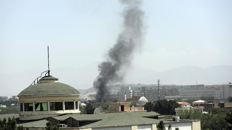 Anti-missile decoy flares are deployed as U.S. Black Hawk military helicopters and a dirigible balloon fly over the city of Kabul, Afghanistan, Sunday, Aug. 15, 2021. Taliban fighters entered the outskirts of the Afghan capital on Sunday and said they were awaiting a “peaceful transfer” of the city after promising not to take it by force, but amid the uncertainty panicked workers fled government offices and helicopters landed at the U.S. Embassy. (AP Photo/Rahmat Gul)
