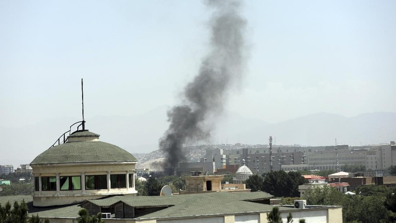 Anti-missile decoy flares are deployed as U.S. Black Hawk military helicopters and a dirigible balloon fly over the city of Kabul, Afghanistan, Sunday, Aug. 15, 2021. Taliban fighters entered the outskirts of the Afghan capital on Sunday and said they were awaiting a “peaceful transfer” of the city after promising not to take it by force, but amid the uncertainty panicked workers fled government offices and helicopters landed at the U.S. Embassy. (AP Photo/Rahmat Gul)
