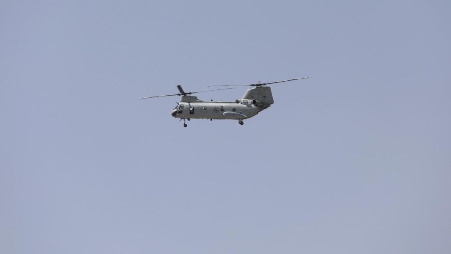Anti-missile decoy flares are deployed as U.S. Black Hawk military helicopters and a dirigible balloon fly over the city of Kabul, Afghanistan, Sunday, Aug. 15, 2021. Taliban fighters entered the outskirts of the Afghan capital on Sunday and said they were awaiting a “peaceful transfer” of the city after promising not to take it by force, but amid the uncertainty panicked workers fled government offices and helicopters landed at the U.S. Embassy. (AP Photo/Rahmat Gul)