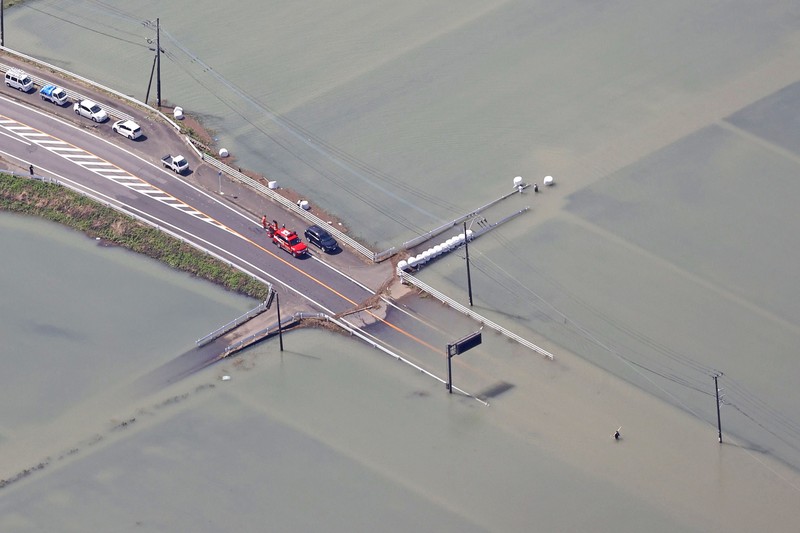 Roads are submerged in water after torrential rain in Takeo, Saga prefecture, southwestern Japan, Sunday, Aug. 15, 2021. Heavy rain has dumped on southwestern Japan since last week. (Kyodo News via AP)