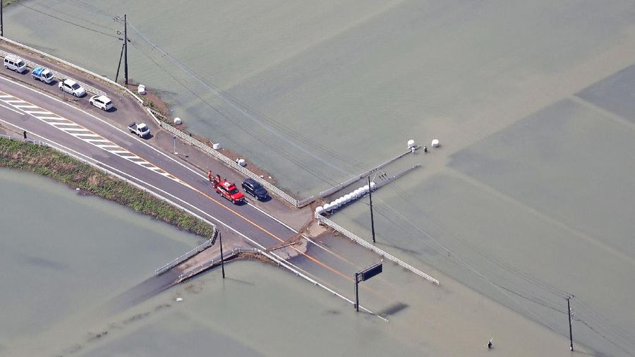 Roads are submerged in water after torrential rain in Takeo, Saga prefecture, southwestern Japan, Sunday, Aug. 15, 2021. Heavy rain has dumped on southwestern Japan since last week. (Kyodo News via AP)