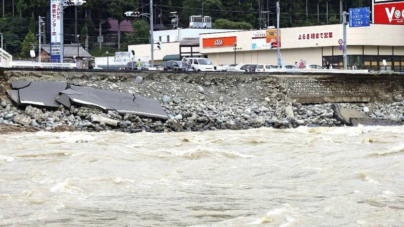 Roads are submerged in water after torrential rain in Takeo, Saga prefecture, southwestern Japan, Sunday, Aug. 15, 2021. Heavy rain has dumped on southwestern Japan since last week. (Kyodo News via AP)