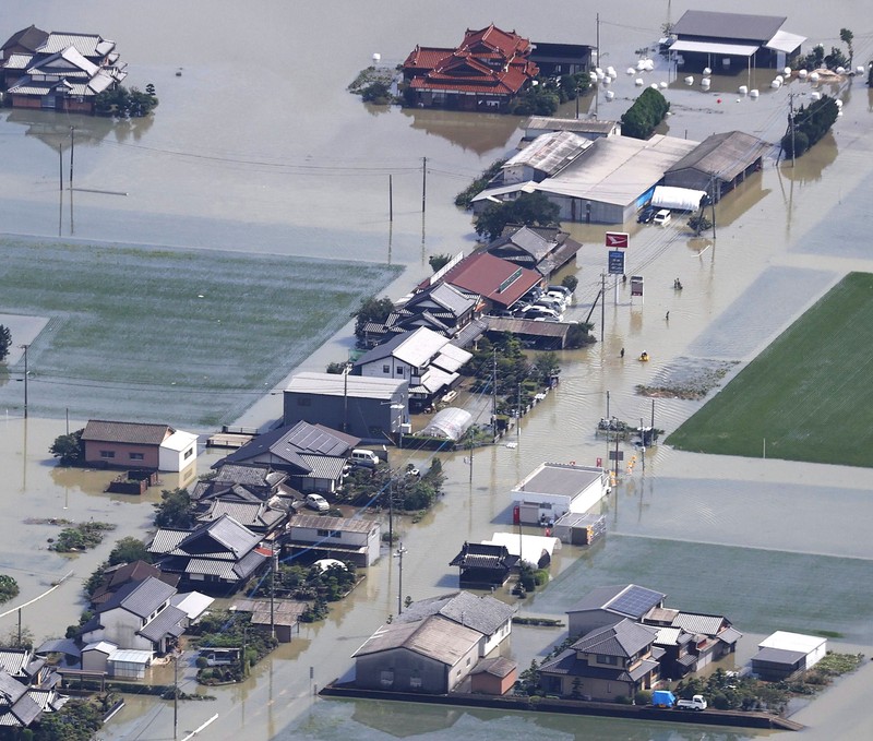 Japan Heavy Rain Roads are submerged in water after torrential rain in Takeo, Saga prefecture, southwestern Japan, Sunday, Aug. 15, 2021. Heavy rain has dumped on southwestern Japan since last week. (Kyodo News via AP)