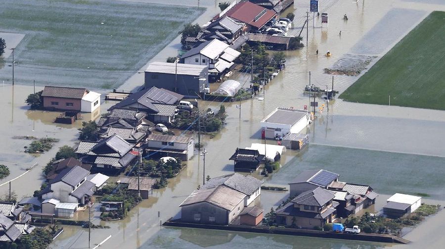 Roads are submerged in water after torrential rain in Takeo, Saga prefecture, southwestern Japan, Sunday, Aug. 15, 2021. Heavy rain has dumped on southwestern Japan since last week. (Kyodo News via AP)