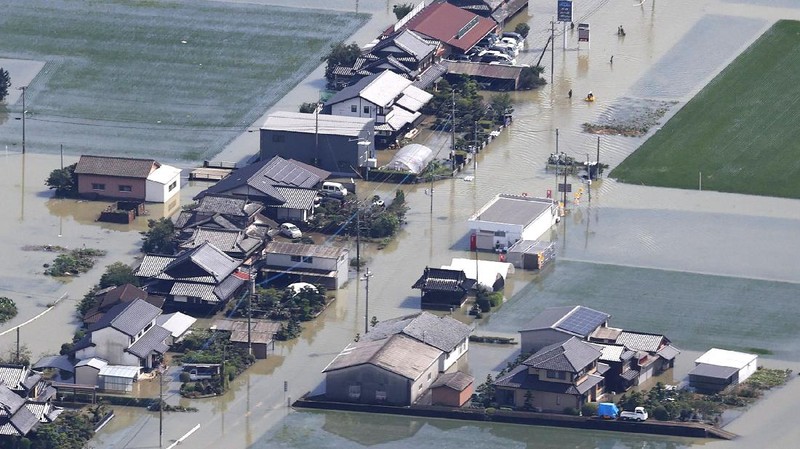 Roads are submerged in water after torrential rain in Takeo, Saga prefecture, southwestern Japan, Sunday, Aug. 15, 2021. Heavy rain has dumped on southwestern Japan since last week. (Kyodo News via AP)