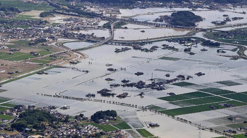 Roads are submerged in water after torrential rain in Takeo, Saga prefecture, southwestern Japan, Sunday, Aug. 15, 2021. Heavy rain has dumped on southwestern Japan since last week. (Kyodo News via AP)
