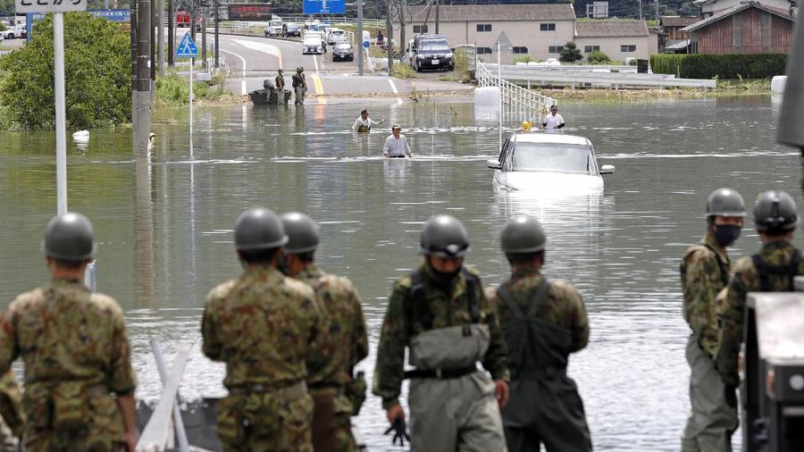 Roads are submerged in water after torrential rain in Takeo, Saga prefecture, southwestern Japan, Sunday, Aug. 15, 2021. Heavy rain has dumped on southwestern Japan since last week. (Kyodo News via AP)