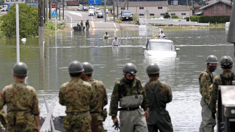 Roads are submerged in water after torrential rain in Takeo, Saga prefecture, southwestern Japan, Sunday, Aug. 15, 2021. Heavy rain has dumped on southwestern Japan since last week. (Kyodo News via AP)