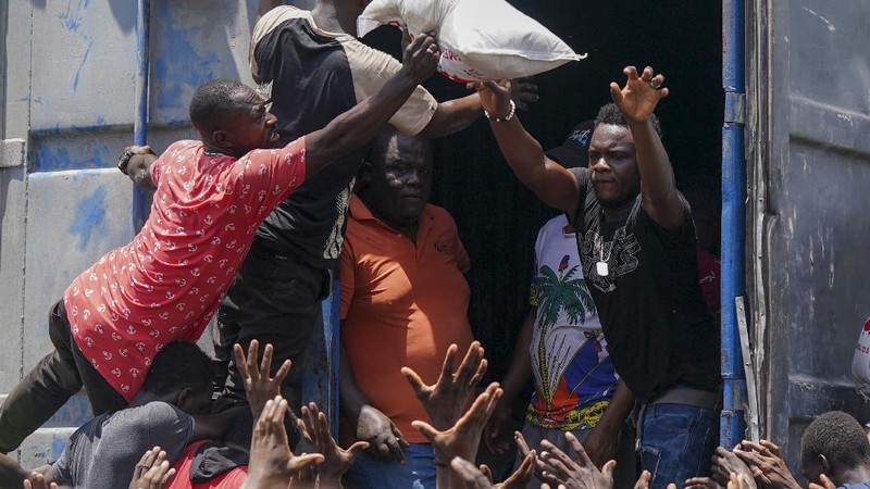 Korban gempa Haiti berebut sembako saat bantuan datang. (AP/Fernando Llano)