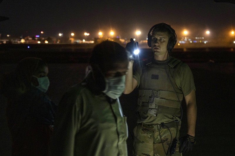 US Afghanistan In this Aug. 20, 2021, photo provided by the U.S. Marine Corps, U.S. Marines and Norweigian coalition forces assist with security at an Evacuation Control Checkpoint ensuring evacuees are processed safely during an evacuation at Hamid Karzai International Airport in Kabul, Afghanistan. (Staff Sgt. Victor Mancilla/U.S. Marine Corps via AP)