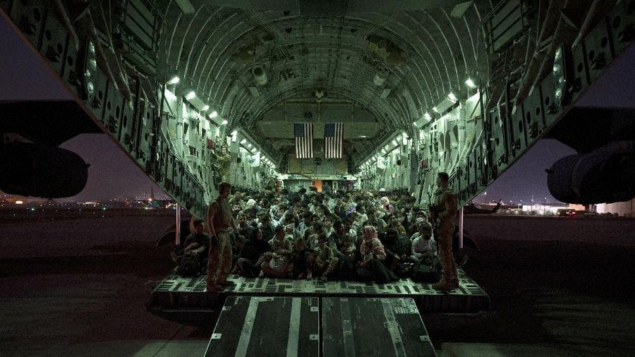 In this Aug. 20, 2021, photo provided by the U.S. Marine Corps, U.S. Marines and Norweigian coalition forces assist with security at an Evacuation Control Checkpoint ensuring evacuees are processed safely during an evacuation at Hamid Karzai International Airport in Kabul, Afghanistan. (Staff Sgt. Victor Mancilla/U.S. Marine Corps via AP)