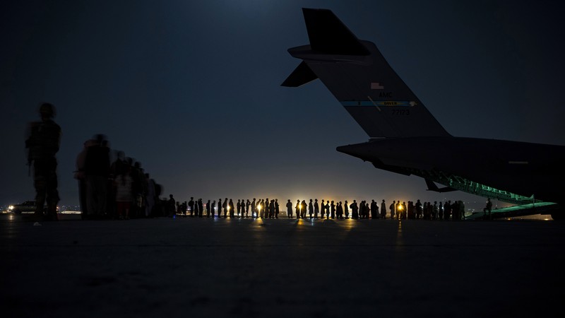 US Afghanistan In this Aug. 20, 2021, photo provided by the U.S. Marine Corps, U.S. Marines and Norweigian coalition forces assist with security at an Evacuation Control Checkpoint ensuring evacuees are processed safely during an evacuation at Hamid Karzai International Airport in Kabul, Afghanistan. (Staff Sgt. Victor Mancilla/U.S. Marine Corps via AP)