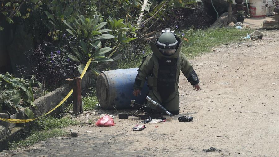 A member of the police bomb disposal squad leave s the scene after destroying a suspicious package found inside a garbage can in Bekasi on the outskirts of Jakarta, Indonesia, Monday, Aug. 23, 2021. Indonesia, the world's most populous Muslim nation, has carried out a sustained crackdown on Islamic militants since bombings on the tourist island of Bali in 2002 killed 202 people, mostly foreigners. Recently, attacks on foreign interests have been largely replaced in recent years by smaller, less deadly strikes targeting the government, mainly police and anti-terrorism forces. (AP Photo/Achmad Ibrahim)