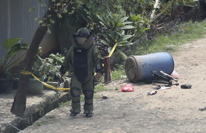 A member of the police bomb disposal squad leave s the scene after destroying a suspicious package found inside a garbage can in Bekasi on the outskirts of Jakarta, Indonesia, Monday, Aug. 23, 2021. Indonesia, the world's most populous Muslim nation, has carried out a sustained crackdown on Islamic militants since bombings on the tourist island of Bali in 2002 killed 202 people, mostly foreigners. Recently, attacks on foreign interests have been largely replaced in recent years by smaller, less deadly strikes targeting the government, mainly police and anti-terrorism forces. (AP Photo/Achmad Ibrahim)