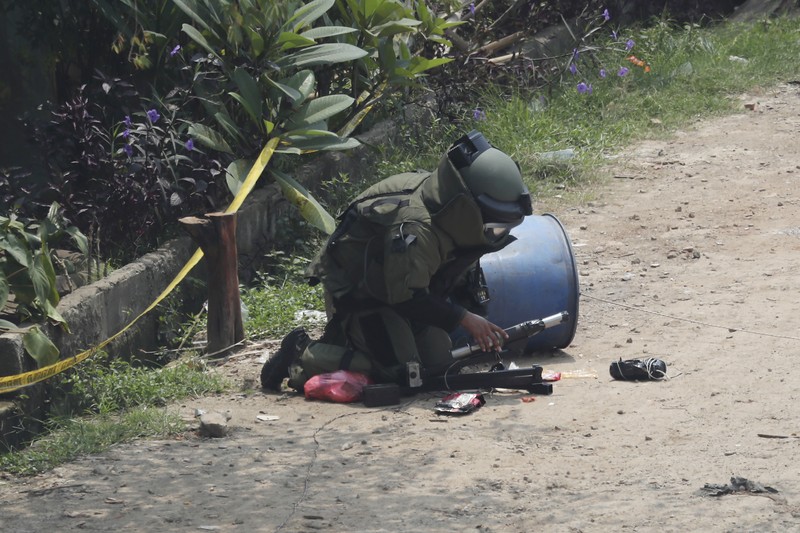 A member of the police bomb disposal squad leave s the scene after destroying a suspicious package found inside a garbage can in Bekasi on the outskirts of Jakarta, Indonesia, Monday, Aug. 23, 2021. Indonesia, the world's most populous Muslim nation, has carried out a sustained crackdown on Islamic militants since bombings on the tourist island of Bali in 2002 killed 202 people, mostly foreigners. Recently, attacks on foreign interests have been largely replaced in recent years by smaller, less deadly strikes targeting the government, mainly police and anti-terrorism forces. (AP Photo/Achmad Ibrahim)