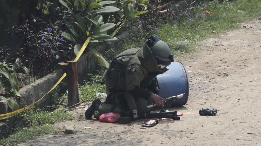 A member of the police bomb disposal squad leave s the scene after destroying a suspicious package found inside a garbage can in Bekasi on the outskirts of Jakarta, Indonesia, Monday, Aug. 23, 2021. Indonesia, the world's most populous Muslim nation, has carried out a sustained crackdown on Islamic militants since bombings on the tourist island of Bali in 2002 killed 202 people, mostly foreigners. Recently, attacks on foreign interests have been largely replaced in recent years by smaller, less deadly strikes targeting the government, mainly police and anti-terrorism forces. (AP Photo/Achmad Ibrahim)