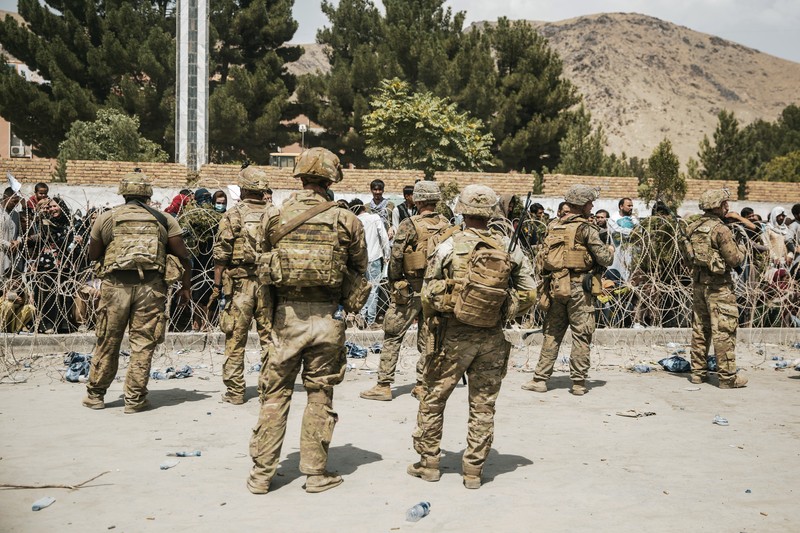 US Afghanistan In this Aug. 20, 2021, photo provided by the U.S. Marine Corps, U.S. Marines and Norweigian coalition forces assist with security at an Evacuation Control Checkpoint ensuring evacuees are processed safely during an evacuation at Hamid Karzai International Airport in Kabul, Afghanistan. (Staff Sgt. Victor Mancilla/U.S. Marine Corps via AP)