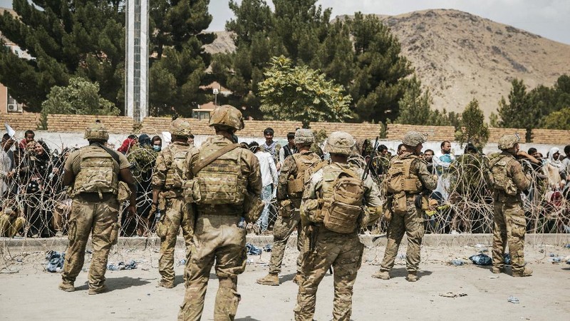 In this Aug. 20, 2021, photo provided by the U.S. Marine Corps, U.S. Marines and Norweigian coalition forces assist with security at an Evacuation Control Checkpoint ensuring evacuees are processed safely during an evacuation at Hamid Karzai International Airport in Kabul, Afghanistan. (Staff Sgt. Victor Mancilla/U.S. Marine Corps via AP)
