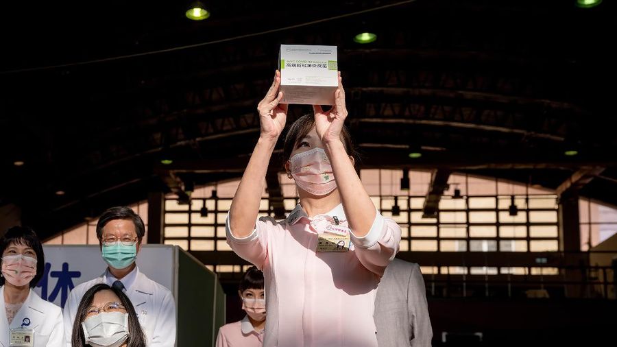 In this photo released by the Taiwan Presidential Office, Taiwanese President Tsai Ing-wen, center, receives her first shot of the island's first domestically developed coronavirus vaccine made by Medigen Vaccine Biologics Corp. at the Taiwan University Hospital in Taipei, Taiwan on Monday, Aug. 23, 2021. The vaccine was given emergency approval by regulators in July using a shortcut that prompted fierce opposition from parts of Taiwan's medical and scientific community. (Taiwan Presidential Office via AP)